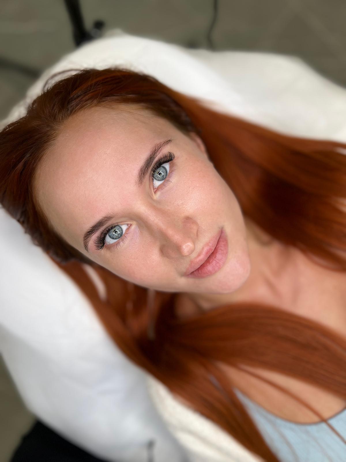 Red-haired woman with long lashes